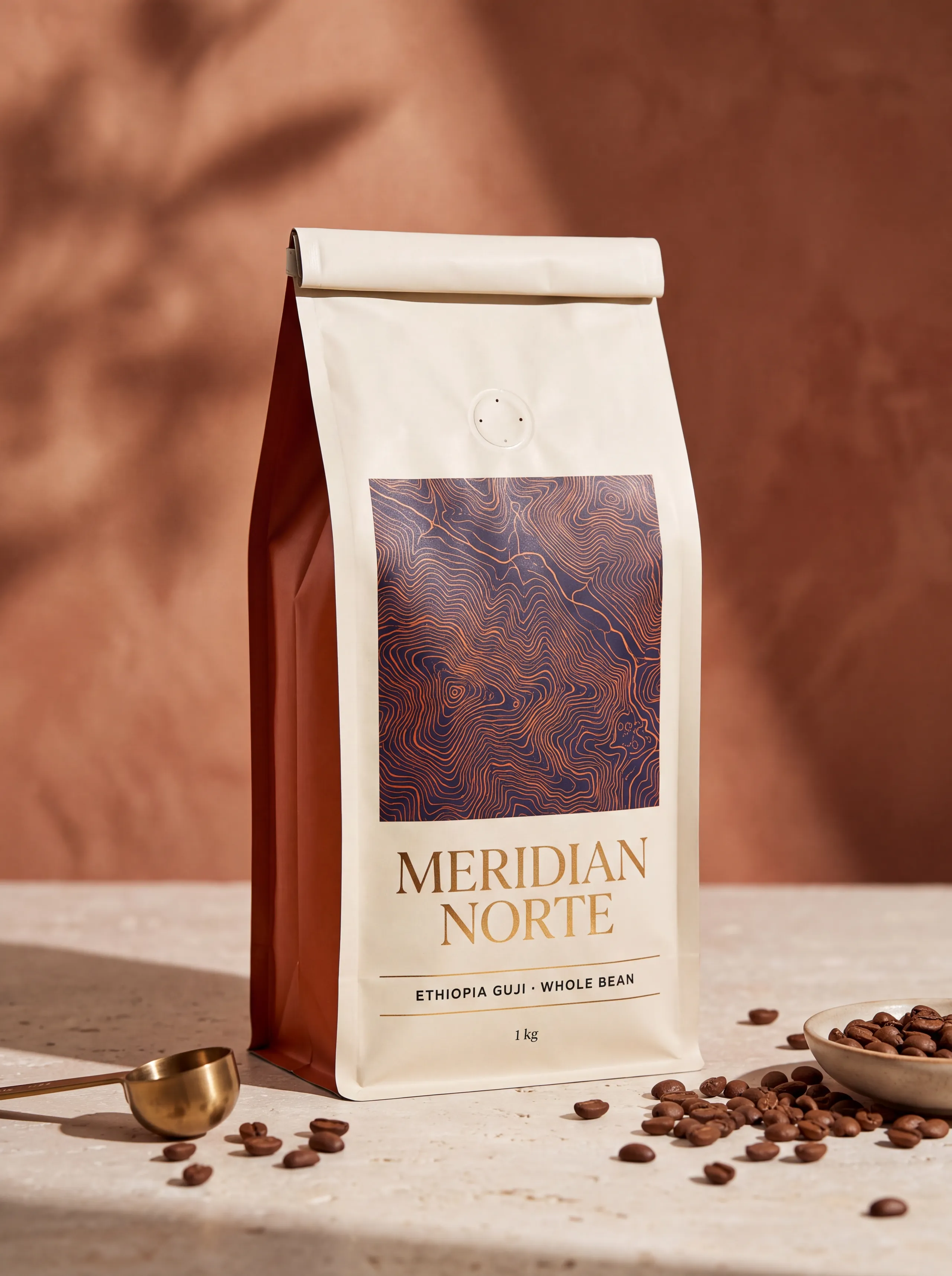 A flat-bottom coffee pouch standing square on its rectangular base, both side gussets sharply creased and a one-way degassing valve on the front.